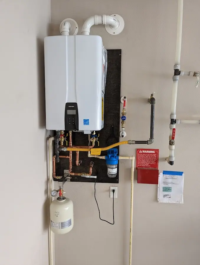 Professional plumber installing copper piping in a Pearland home